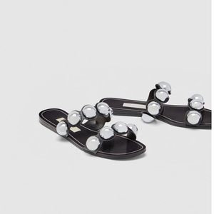 black slides with silver balls